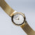 Orologio da donna Bering con bracciale in maglia color oro e quadrante chiaro, angolato