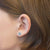 Prinzessin Lillifee Stern-Ohrstecker mit hellblauen, rosa und weißen Steinchen am Ohr, silberfarben