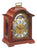 Orologio da tavolo in mogano con quadrante rotondo e cornice decorata, frontale chiuso