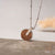 Collana con ciondolo rotondo in legno e occhiello su catena d'argento