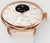Damen Smartwatch mit roségoldfarbenem Gehäuse, beigem Band und Temp-Anzeige auf schwarzem Zifferblatt.