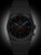 Orologio da uomo con bracciale in metallo scuro, quadrante scuro con indici blu, data 25