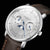 Alt text: Orologio Naos con quadrante a fasi lunari, cinturino in pelle marrone e cassa in acciaio inossidabile color oro.
