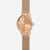 Orologio Naos XS Edition Elyra in oro rosa con cinturino Milanaise, vista da 45 gradi su sfondo grigio