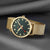Goldfarbene Herrenuhr mit dunkelgrünem Zifferblatt, roten Zeigern und Mesh-Band