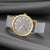Unisex-Armbanduhr mit hellgrauem Zifferblatt, goldfarbener Lünette, roten Zeigern, grauem Band.