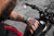 Orologio da uomo al polso con cinturino nero accanto a una moto