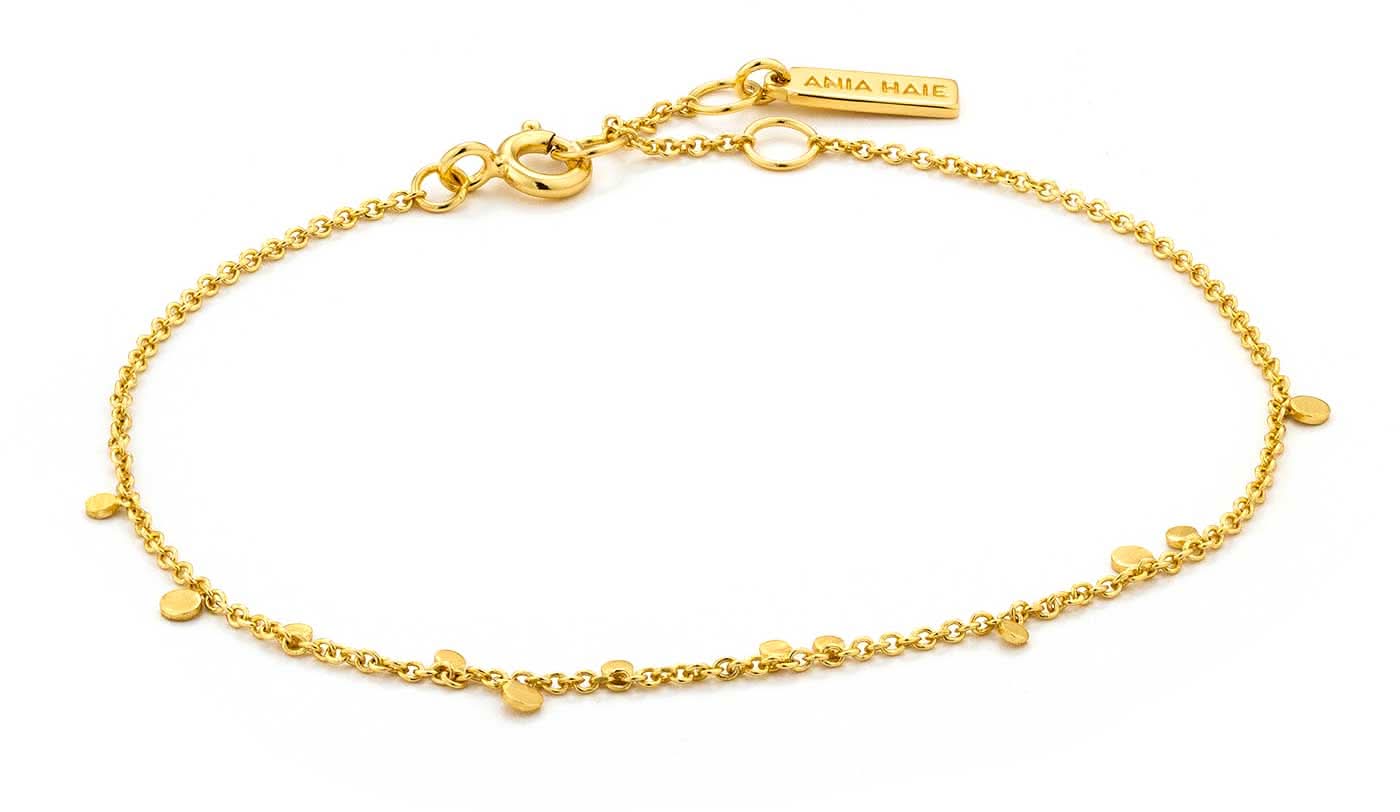 Bracciale color oro con piccoli pendenti a disco e maglie, chiusura