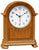 Orologio da tavolo in legno con cassa bombata e quadrante bianco, lancette nere.