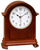 Orologio da tavolo in legno con quadrante rotondo e lancette dorate, cornice curva