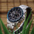 Silberne Herrenuhr am Metallarmband, blau-schwarzes Zifferblatt mit Chronograph