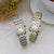 Zwei Damenuhren mit Metallarmbändern: silber und zweifarbig gold/silber, weißes Zifferblatt