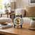 Orologio da tavolo meccanico con movimento a vista color oro, quadrante rotondo su credenza in legno