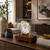 Orologio da tavolo in cassa di vetro con quadrante bianco, elementi in ottone e base in noce