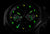 Orologio da uomo con quadrante scuro e indici luminescenti verdi, cassa nera