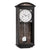 Orologio da parete con cassa in legno scuro, quadrante bianco e numeri romani, pendolo a vista